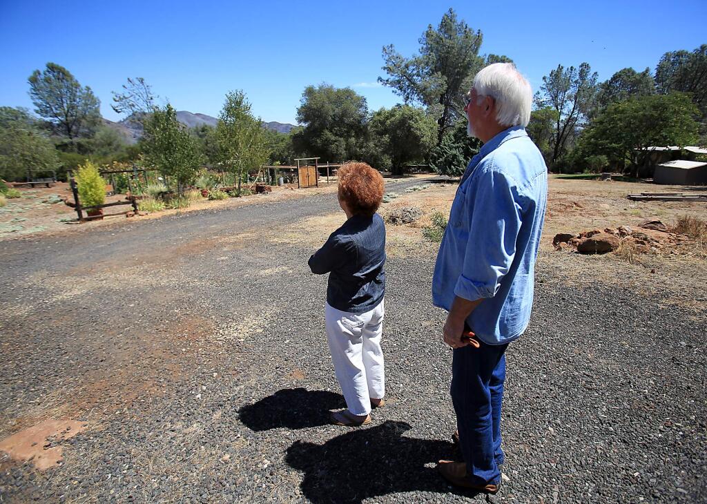 For the first time in days, Liz and Vincent Black have a clear view of the mountains above Jerusalem Valley in Lake County, Friday Aug. 14, 2015. During the last three weeks they've been evacuated twice because of the Rocky and Jerusalem fires. (Kent Porter / Press Democrat) 2015lear