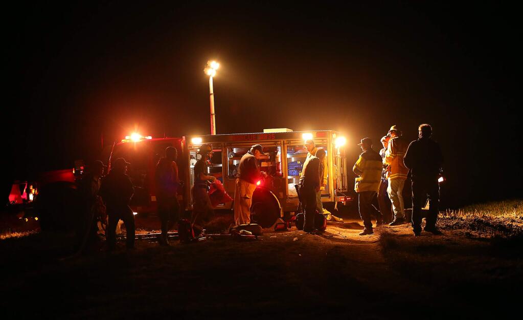 Emergency personnel pack up their gear after participating in the rescue of a 4-year-old boy that fell off a cliff at Bodega Head, in Bodega Bay on Monday, Nov. 10, 2014. (CHRISTOPHER CHUNG/ PD)
