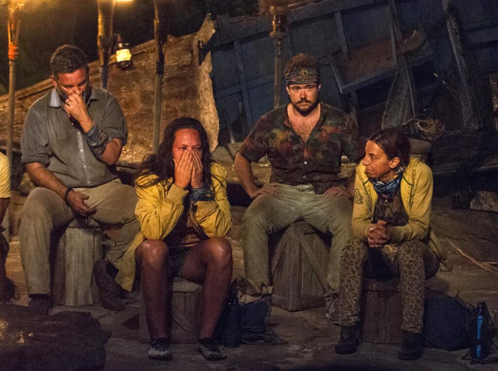 In this image released by CBS, contestants, from left, Jeff Varner, Sarah Lacina, Zeke Smith and Debbie Wanner appear at the Tribal Council portion of the competition series 'Survivor: Game Changers.' Smith was outed as transgender by fellow competitor Varner on Wednesday night's episode. Varner was immediately criticized by other players. He repeatedly apologized, but was voted out of the competition. (Jeffrey Neira/CBS via AP)