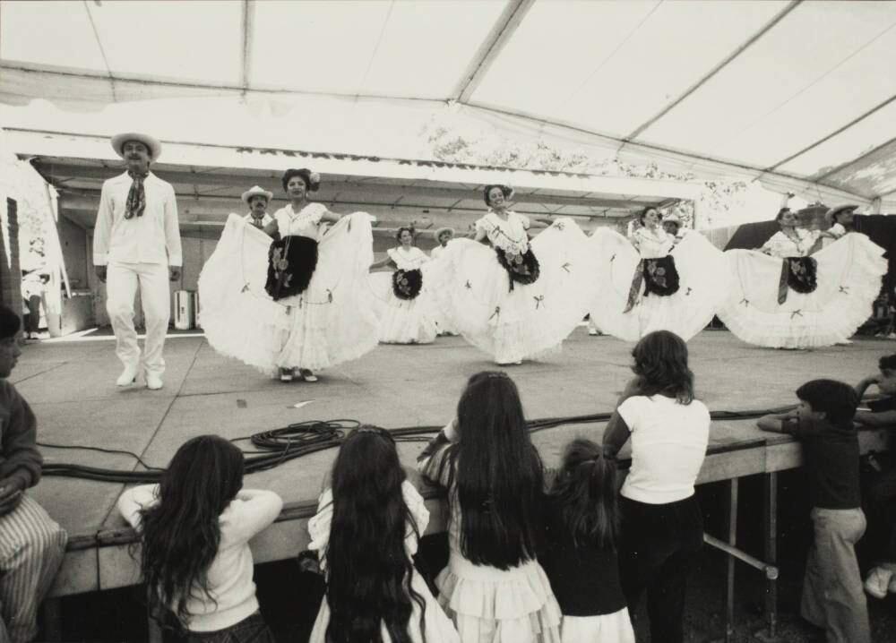 A folklorico dance troupe performs on stage at the Sonoma County Fair Mexican Village with group of youngsters watching. (Courtesy of the Sonoma County Library)