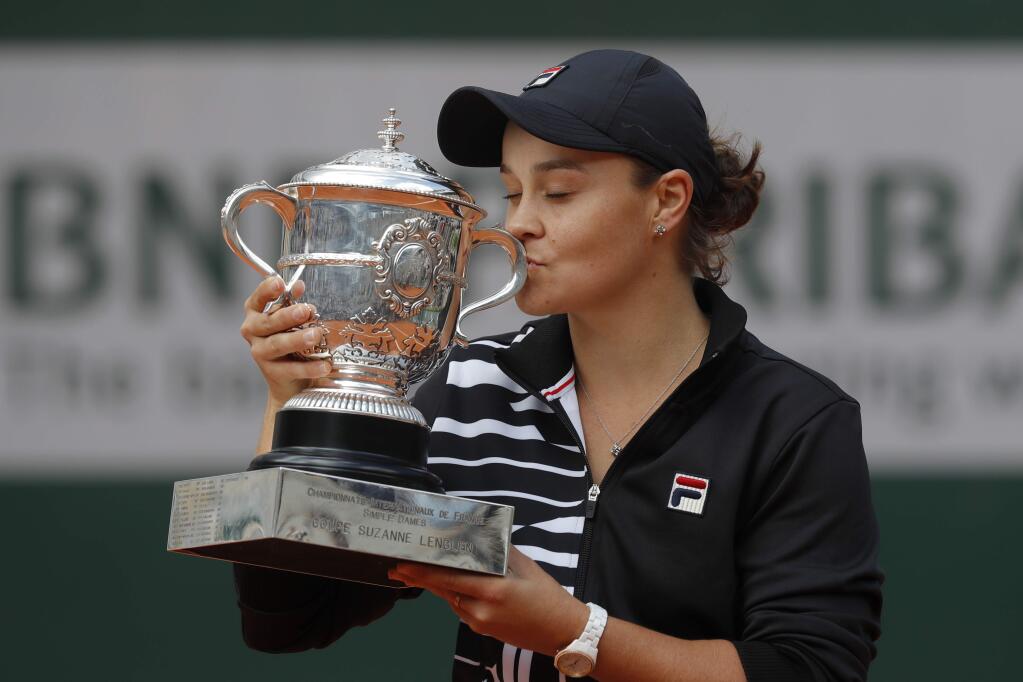 Australia's Ashleigh Barty kisses the trophy as she celebrates winning her women's final at the French Open tennis tournament against Marketa Vondrousova of the Czech Republic in two sets 6-1, 6-3, at the Roland Garros stadium in Paris, Saturday, June 8, 2019. (AP Photo/Michel Euler)