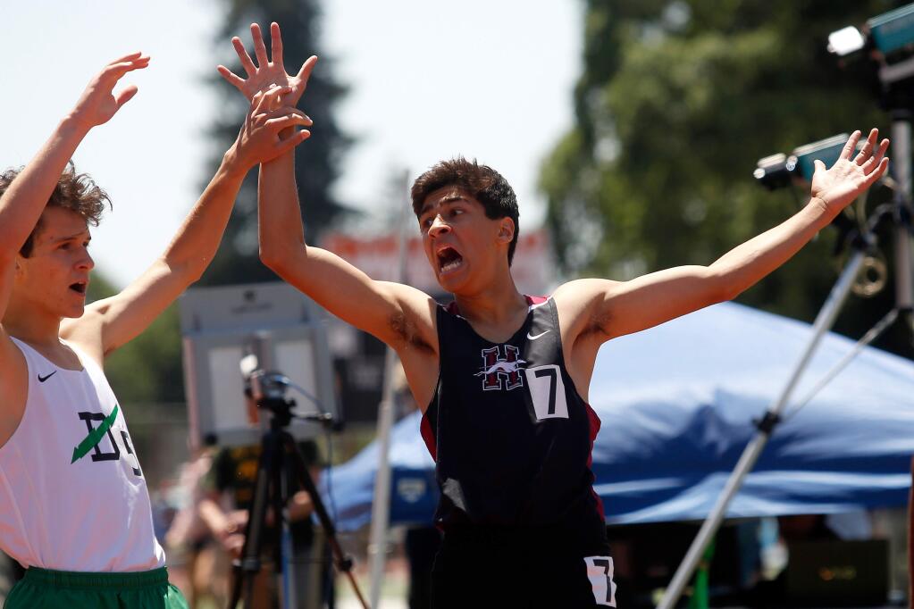 Healdsburg's Dante Godinez, right, reacts with surprise after he finished third in his heat of the boys 800-meter race during the Redwood Empire Track and Field Championships at Santa Rosa High School on Saturday, May 19, 2018. (Alvin Jornada / The Press Democrat)