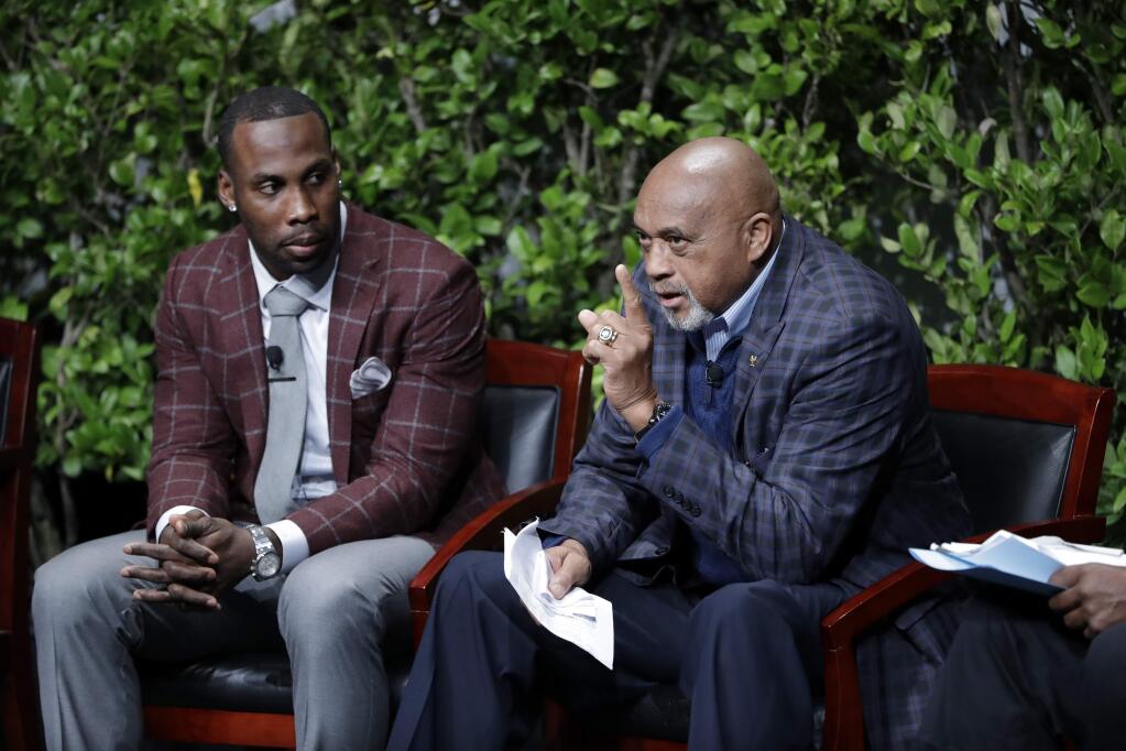Former U.S. Olympian Tommie Smith, right, speaks as NFL wide receiver Anquan Boldin listens during a sports and activism panel entitled 'From Protest to Progress: Next Steps' on Tuesday, Jan. 24, 2017, in San Jose. (AP Photo/Marcio Jose Sanchez)