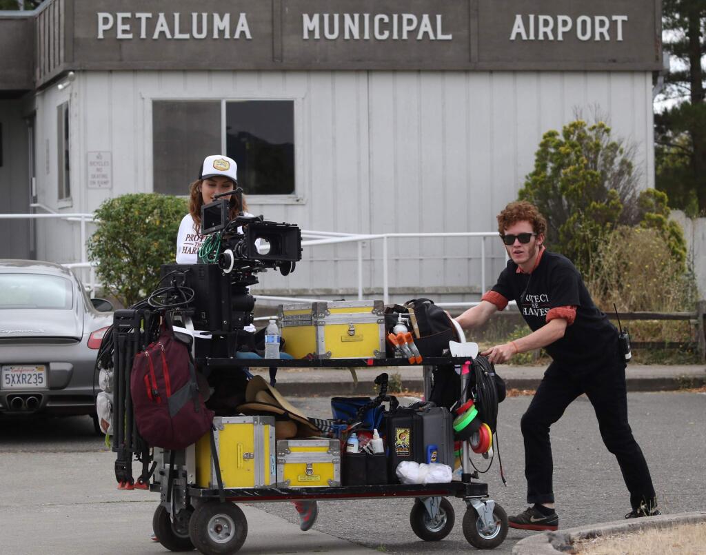 A film crew for ESX Entertainment works filming 'Running Wild' a movie co-produced by Petaluma's Ali Afshar and Forrest Lucas, directed by Alex Ranarivelo, and staring Sharon Stone at the Petaluma Municipal Airport in Petaluma on Friday, August 21, 2015. (SCOTT MANCHESTER/ARGUS-COURIER STAFF)