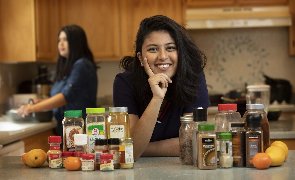 John Burgess / The Press DemocratMaria Carrillo sophomore Zoya Ahmed, with her mom in background, was a finalist in the state Poetry Out Loud contest and won the Poetry Ourselves competition with her poem about spices of Pakistani cooking.