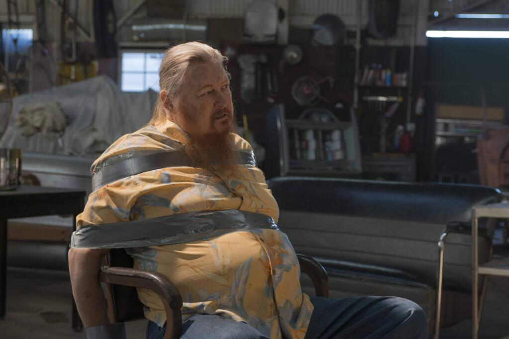 This image released by FX shows Mickey Jones as Rodney 'Hot Rod' Dunham in a scene from 'Justified.' Jones, 76, a native of Houston, Texas, native, who worked steadily in TV and film since the 1970s, died early Wednesday of the effects of a long illness. The illness was not disclosed. (Prashant Gupta/FX via AP)