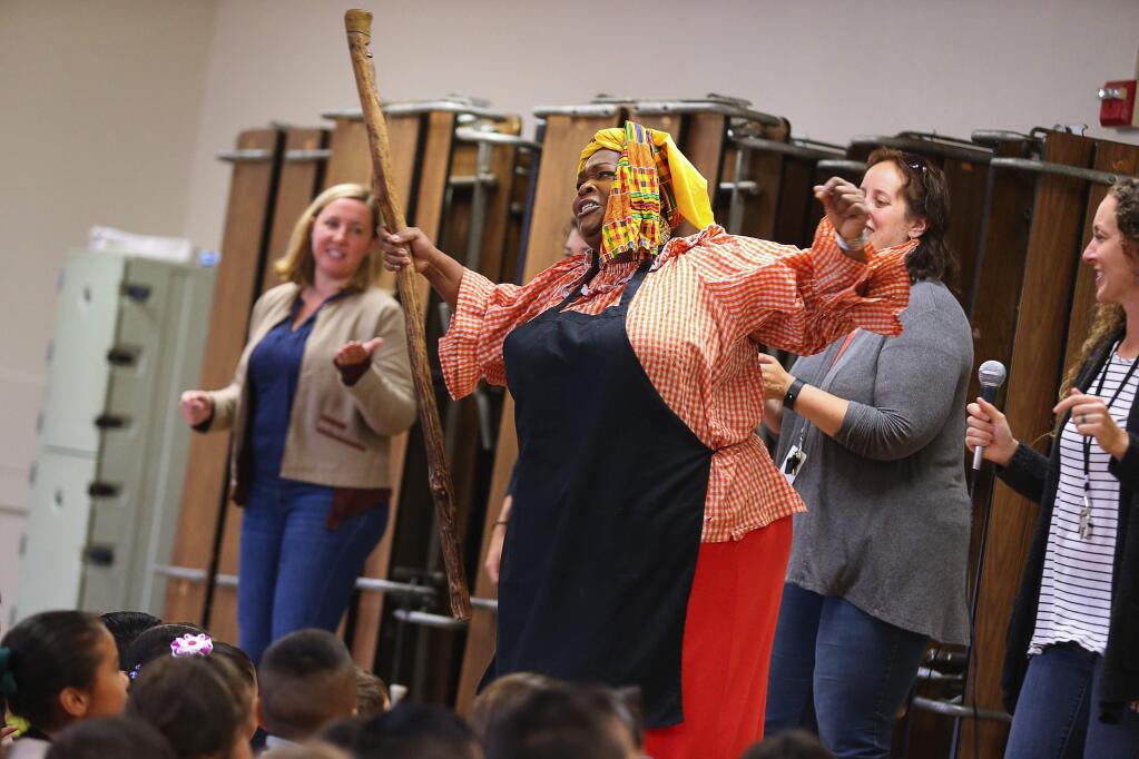Anita Singleton-Prather leads students in song as Auntie Pearlie Sue, at Cesar Chavez Language Academy, in Santa Rosa, on Monday, August 22, 2016. (Christopher Chung/ The Press Democrat)