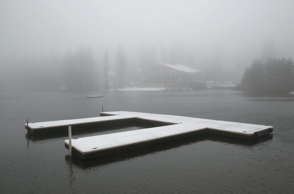 Snow blankets docks at Serene Lakes, near Soda Springs, Calif., Friday, Nov. 3, 2017. A light snow fell in the upper elevations of the Sierra Nevada overnight, with up to 2 feet of snow forecast to fall in elevations above 8,000 feet and at least a foot of snow is expected in Donner and Tioga passes and other areas above 6,000 feet and up this weekend, forecasters said. (AP Photo/Rich Pedroncelli)