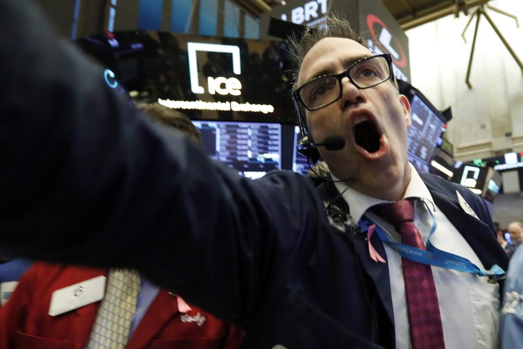 Trader Gregory Rowe works on the floor of the New York Stock Exchange, Tuesday, Oct. 23, 2018. Stocks are opening sharply lower on Wall Street following big drops in Asia and Europe. (AP Photo/Richard Drew)