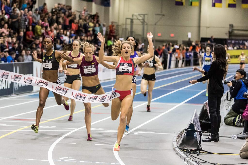 Lauren Wallace raises her arms in celebration as she crosses the finish line first in the women's 1.000-meter run at the USATF Indoor Track & Field Championships in Boston in March. (Photo by Kevin Morris)