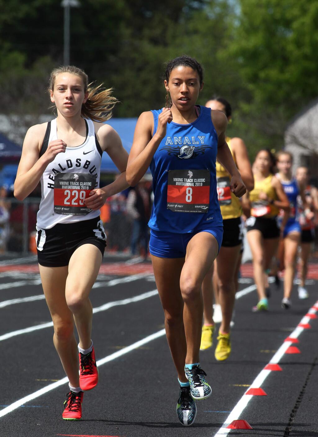 Gabrielle Peterson of Healdsburg High School, left, takes the lead alongside Sierra Atkins of Analy High School, in the 1,600-meter race at the Viking Track Classic at Montgomery High School in Santa Rosa on Saturday, April 20, 2019. (Darryl Bush / For The Press Democrat)