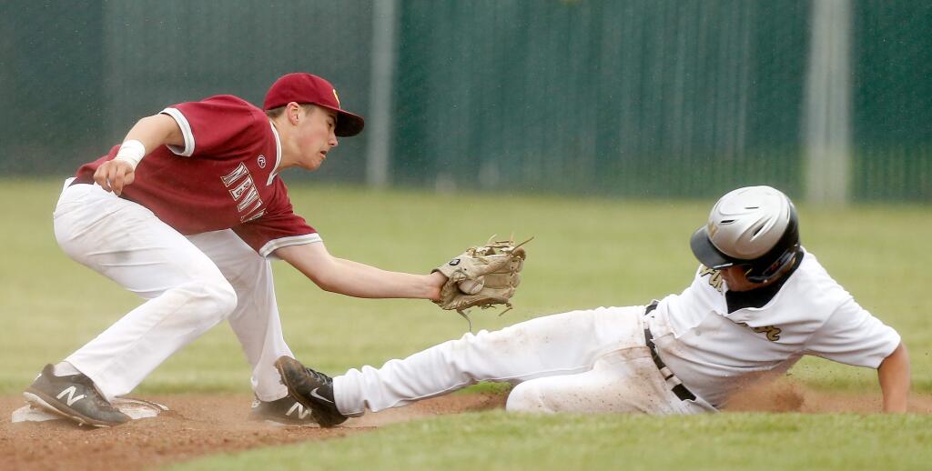 Cardinal Newman's Will Larson (2), left, tags out Windsor's Chris Torres (5) as he slides into second base during a varsity baseball game between Cardinal Newman and Windsor high schools, in Windsor, California, on Wednesday, April 11, 2018. (Alvin Jornada / The Press Democrat)