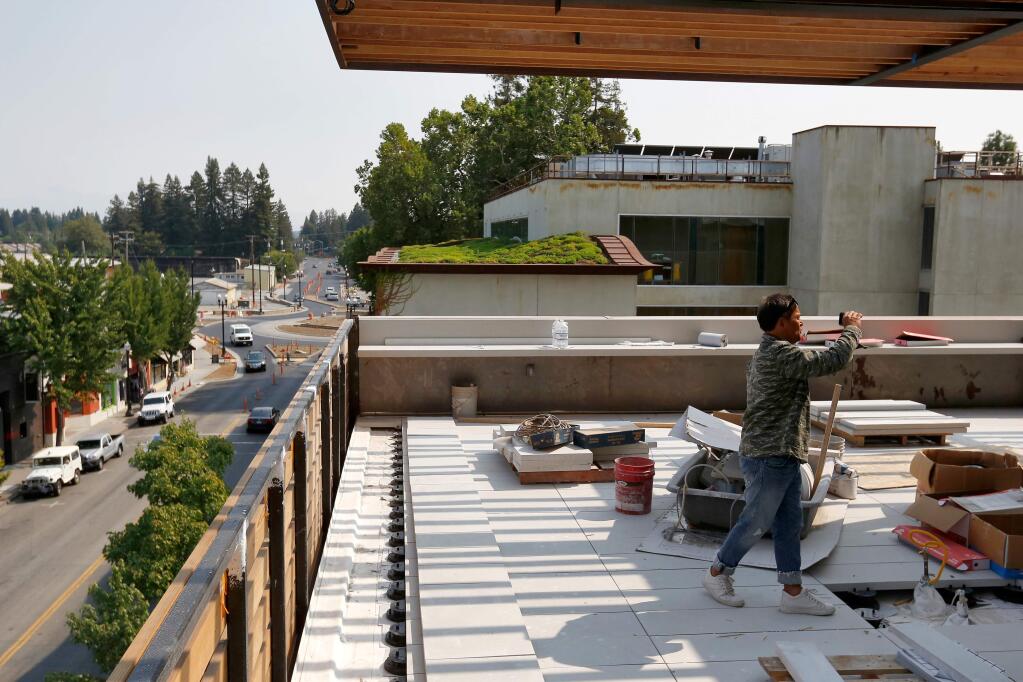 Event coordinator Ken Pacada makes snapshots with his smartphone as he familiarizes himself with the rooftop restaurant patio at Harmon Guest House, which is currently under construction, in Healdsburg, California, on Tuesday, August 21, 2018. (Alvin Jornada / The Press Democrat)