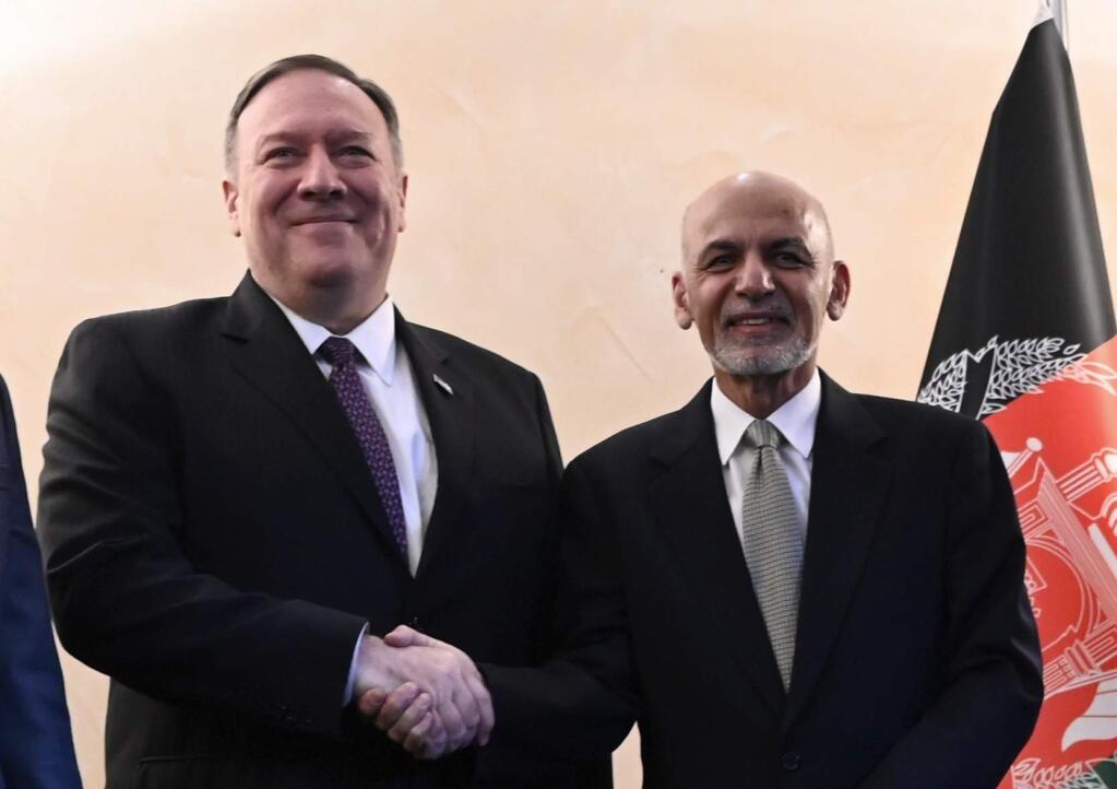 US Secretary of State Mike Pompeo, left, shakes hands with Afghan President Ashraf Ghani during the 56th Munich Security Conference (MSC) in Munich, southern Germany, on Friday, Feb. 14, 2020. The 2020 edition of the Munich Security Conference (MSC) takes place from Feb. 14 to 16. (Andrew Caballero-Reynolds/Pool photo via AP)
