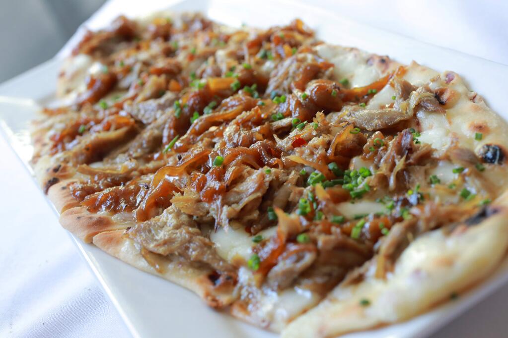 Duck Confit Flatbread with fontina, caramelized onion, chili flakes and chives from the Gravenstein Grill in Sebastopol. (John Burgess/The Press Democrat)