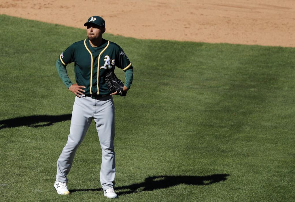 Oakland Athletics' Joakim Soria stands behind the mound waiting to be pulled in the eighth inning of a baseball game against the Texas Rangers in Arlington, Texas, Sunday, April 14, 2019. (AP Photo/Tony Gutierrez)