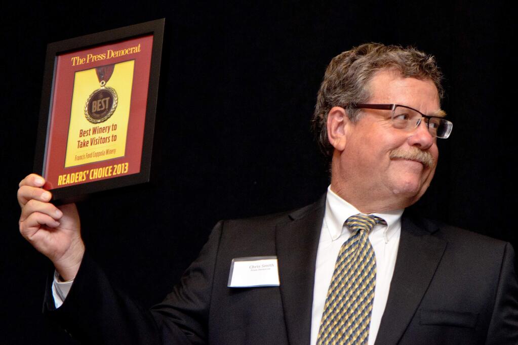 Emcee Chris Smith holds up the award for Best Winery to Take Visitors to, for Francis Ford Coppola Winery, during the Best of Sonoma County Awards Presentation at Hyatt Vineyard Creek, in Santa Rosa, Calif., on September 10, 2013. (Alvin Jornada / For The Press Democrat)