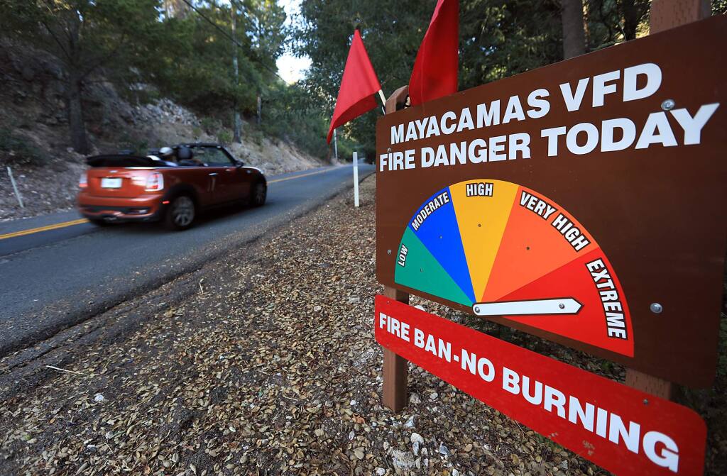 On the Trinity-Oakville grade in eastern Sonoma County, the Mayacamas Volunteer Fire Department displayed red flags for the for the red flag warning posted for the North Bay, Monday Sept. 26, 2017 (Kent Porter / The Press Democrat)