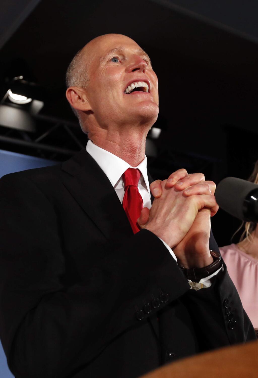 Republican Senate candidate Rick Scott speaks to supporters at an election watch party, Wednesday, Nov. 7, 2018, in Naples, Fla. (AP Photo/Wilfredo Lee)