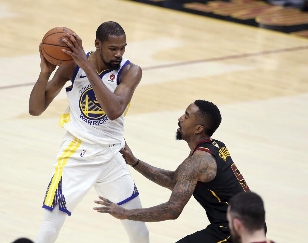 The Golden State Warriors' Kevin Durant is defended by the Cleveland Cavaliers' JR Smith during the second half of Game 4 of the NBA Finals, Friday, June 8, 2018, in Cleveland. (AP Photo/Carlos Osorio)
