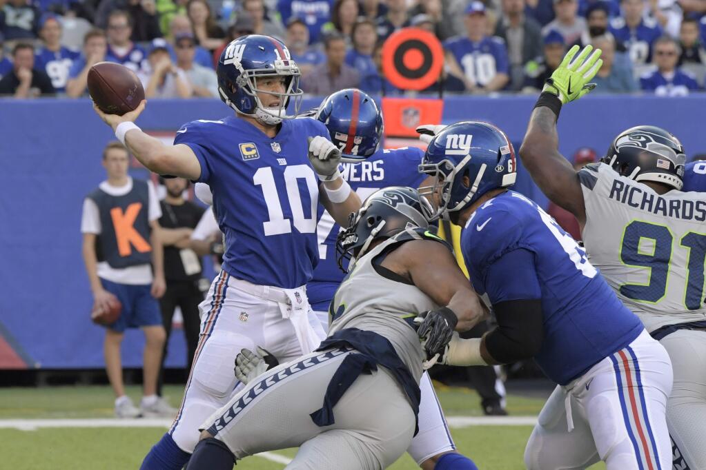New York Giants quarterback Eli Manning throws during the first half against the Seattle Seahawks, Sunday, Oct. 22, 2017, in East Rutherford, N.J. (AP Photo/Bill Kostroun)