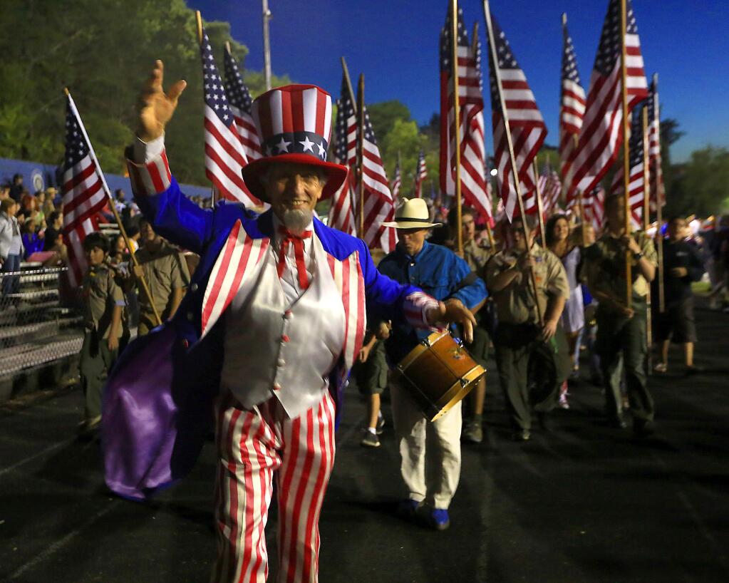 Uncle Sam leads the parade of flags at the July 3rd Fireworks and Music Extravaganza at Analy High School in Sebastopol. (JOHN BURGESS / The Press Democrat)
