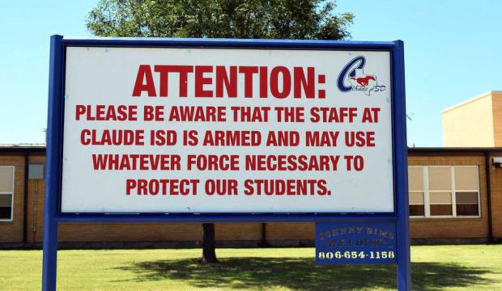 This August 2016 photo shows a sign outside a school in Claude, Texas, which Claude ISD posts outside their schools. In the aftermath of yet another mass school shooting, President Donald Trump says that if one of the victims, a football coach, had been armed “he would have shot and that would have been the end of it.” Revisiting an idea he raised in his campaign, Trump's comments in favor of allowing teachers to be armed come as lawmakers in several states are wrestling with the idea, including in Florida, where the 17 most recent school shooting victims are being mourned.(Creede Newton/Amarillo Globe-News via AP)