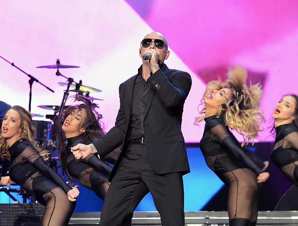 In this photo provided by the Las Vegas News Bureau, Latin Grammy Award winner Pitbull performs during his 'Enrique Iglesias & Pitbull Fall Tour' at Mandalay Bay Events Center in Las Vegas, Sunday, Oct. 12, 2014. (AP Photo/Las Vegas News Bureau, Glenn Pinkerton)