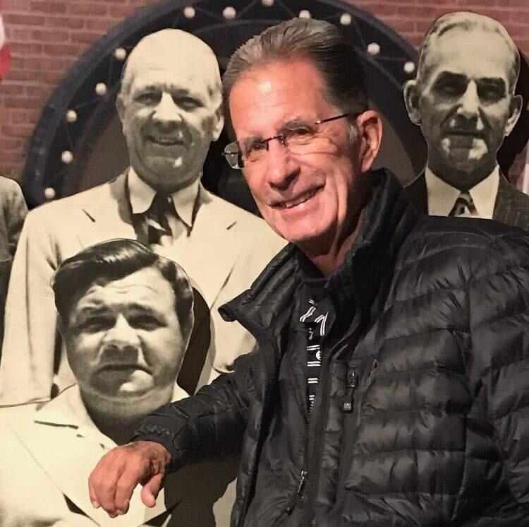 Pete Dardis poses in front of a montage of baseball greats while visiting the Baseball Hall of Fame in Cooperstown, New York, in June. (Photo from Dardis family)