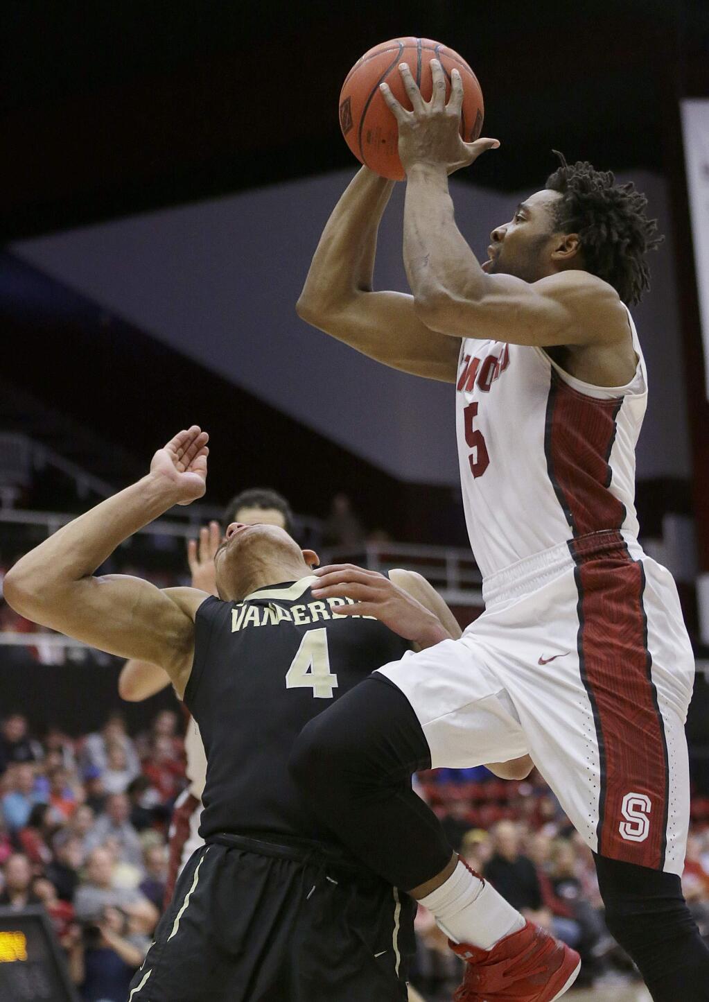 Stanford's Chasson Randle, right, shoots against Vanderbilt's Wade Baldwin IV (4) during the second half of an NCAA college basketball game in the NIT in Stanford, Calif., Tuesday, March 24, 2015. Stanford won 78-75. (AP Photo/Jeff Chiu)