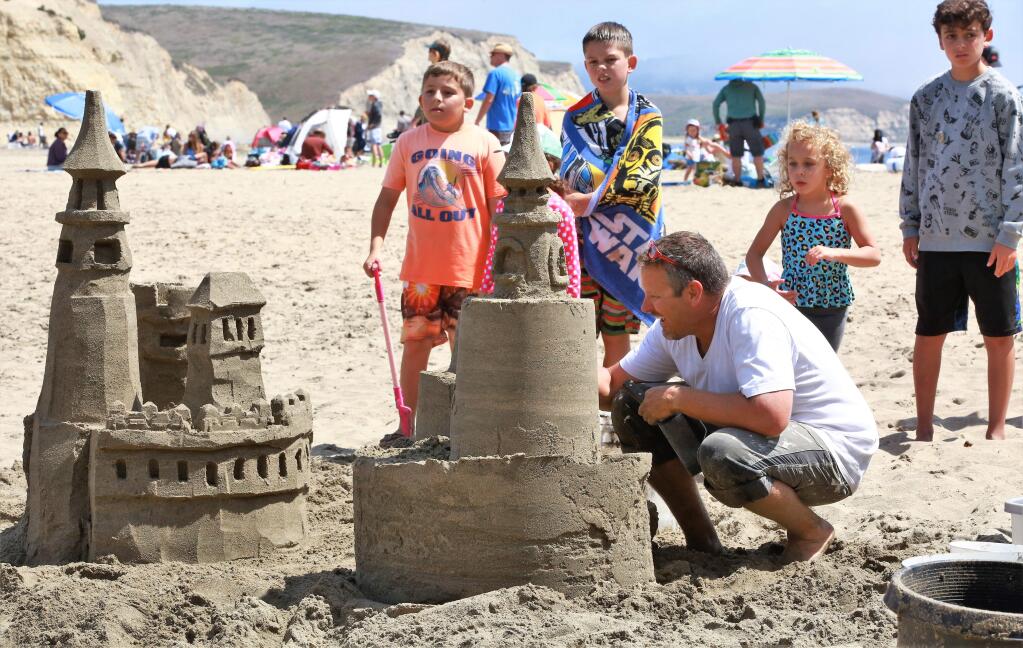 Dan Baker carves the details into his castle at the 38th annual Sand Sculpture Contest at Drakes Beach, Point Reyes National Seashore on Saturday Aug. 25, 2019. (WILL BUCQUOY/FOR THE PD)