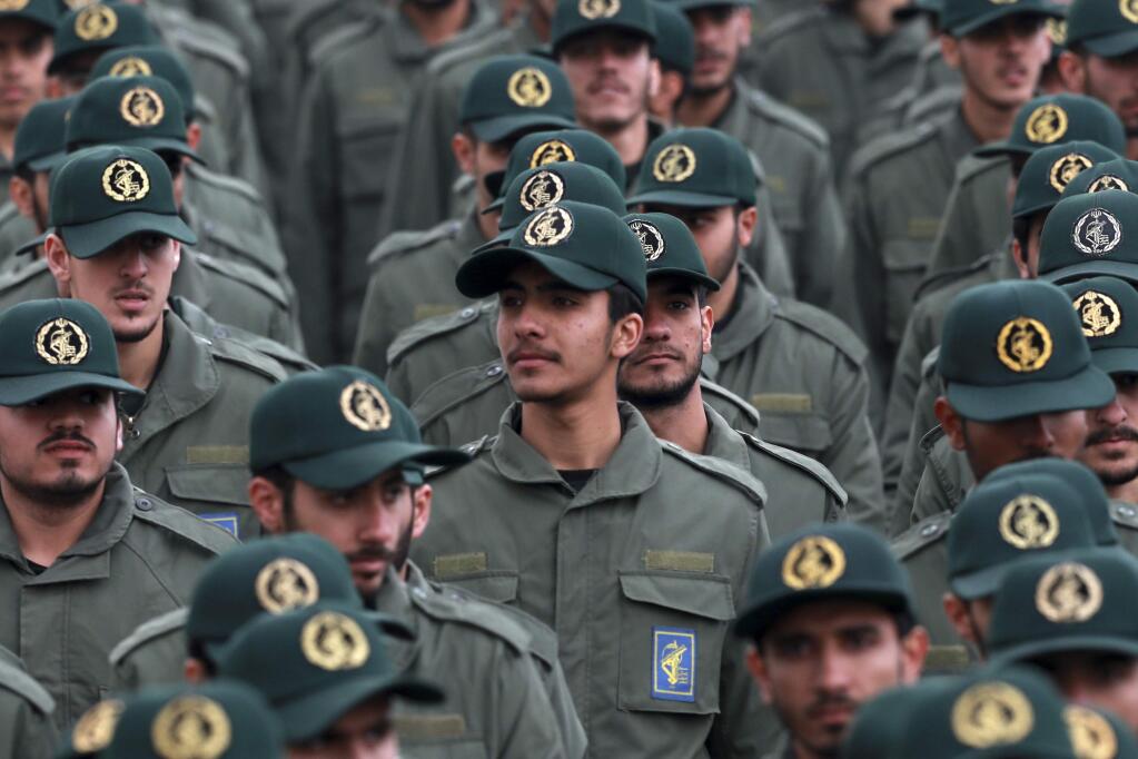 FILE - In this Feb. 11, 2019 file photo, Iranian Revolutionary Guard members attend a ceremony celebrating the 40th anniversary of the Islamic Revolution, at the Azadi, or Freedom, Square in Tehran, Iran. The Trump administration on Wednesday granted important exemptions to new sanctions on Iran's Revolutionary Guard, watering down the effects of the measures while also eliminating an aspect that would have complicated U.S. foreign policy efforts. (AP Photo/Vahid Salemi)