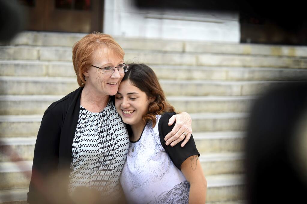 After Reality Winner plead guilty to leaking a classified document, her mother, Billie Winner-Davis, left, gives a hug to her daughter's friend from the Lincoln County Jail, Mikeaela Uscanga, outside the Federal Courthouse in Augusta, Ga., Tuesday, June 26, 2018. Reality Winner has been held in custody for nearly 13 months on a charge of violating the federal Espionage Act. (Michael Holahan/The Augusta Chronicle via AP)