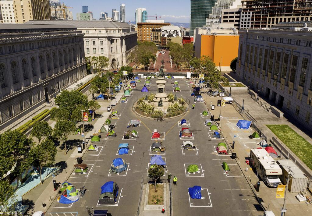 Rectangles designed to help prevent the spread of the coronavirus by encouraging social distancing line a city-sanctioned homeless encampment at San Francisco's Civic Center on Thursday, May 21, 2020. (AP Photo/Noah Berger)