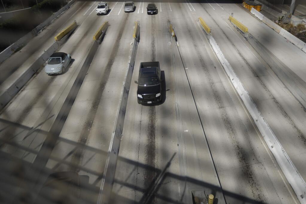 In this Tuesday, Sept. 19, 2017 photo, cars make their way along California's Interstate 5, as they approach the border with Tijuana, Mexico, in San Diego. The busiest border crossing in the United States, between San Diego and Tijuana, will close this weekend to the more than 40,000 cars that pass through it daily to Mexico. The closure is for work on a $741 million expansion project that presents a monumental headache for border businesses, workers, tourists. (AP Photo/Gregory Bull)