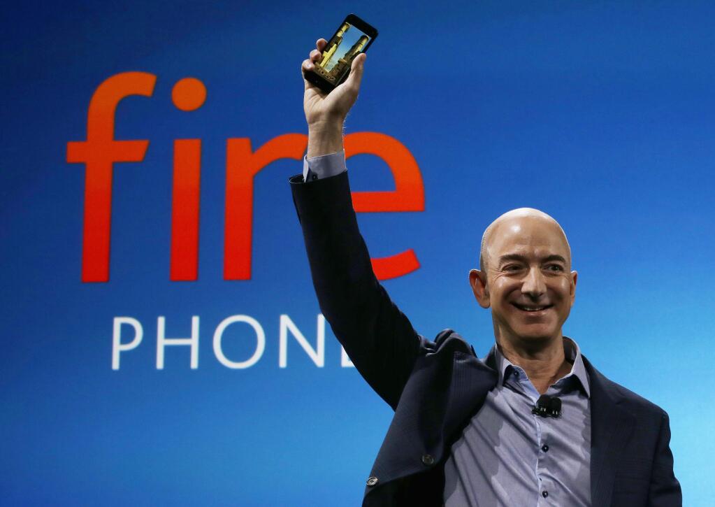 FILE - In this June 18, 2014, file photo, Amazon CEO Jeff Bezos introduces the new Amazon Fire Phone in Seattle. Bloomberg's billionaire index shows Bezos moved past Warren Buffet to become the third richest person in the world on Thursday, July 21, 2016. (AP Photo/Ted S. Warren, File)