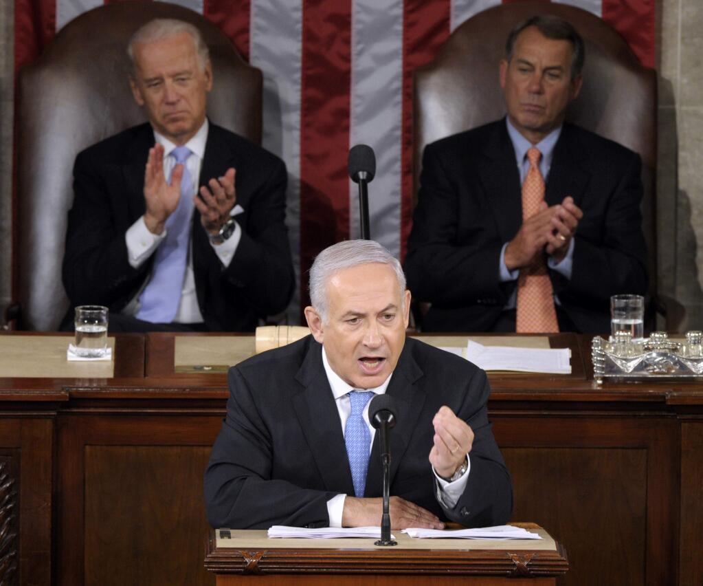 FILE - In this May 24, 2011 file photo, Israeli Prime Minister Benjamin Netanyahu addresses a joint meeting of Congress on Capitol Hill in Washington. Given anywhere else, Israeli Prime Minister Benjamin Netanyahus speech Tuesday wouldnt cause such a fuss. But a foreign leader denouncing U.S. policy from within the grand hall of American democracy upends nearly two centuries of tradition. A joint meeting of Congress, gathering senators and representatives together in the House chamber, is a ceremony typically bestowed on one or two friendly foreign leaders per year. It looks a lot like a presidential State of the Union address. The speaker embodies his or her nation; the audience of lawmakers represents all Americans. Vice President Joe Biden, left, and House Speaker John Boehner of Ohio, right, listen. (AP Photo/Susan Walsh)