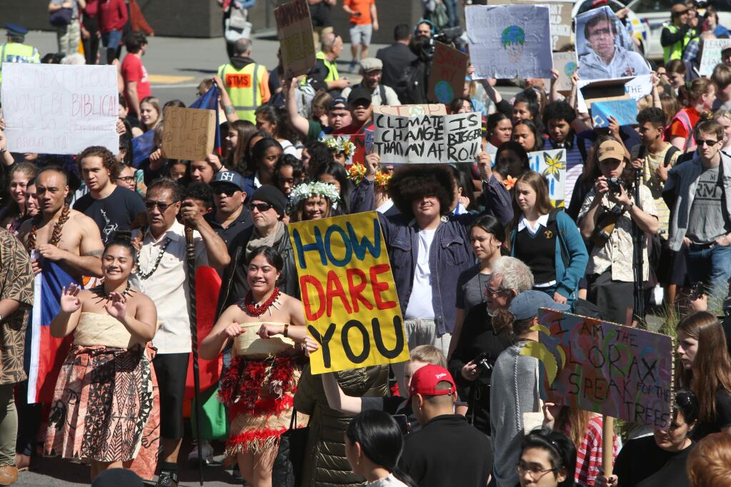 Thousands of people march on Parliament to protest climate change in Wellington, New Zealand, Friday, Sept. 27, 2019. The protest in New Zealand was part of a second wave of protests around the world as the United Nations General Assembly met in New York. (AP Photo/Nick Perry)