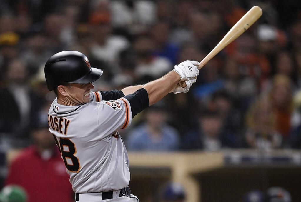The San Francisco Giants' Buster Posey follows through on a two-run double during the sixth inning against the San Diego Padres in San Diego, Thursday, April 12, 2018. (AP Photo/Kelvin Kuo)