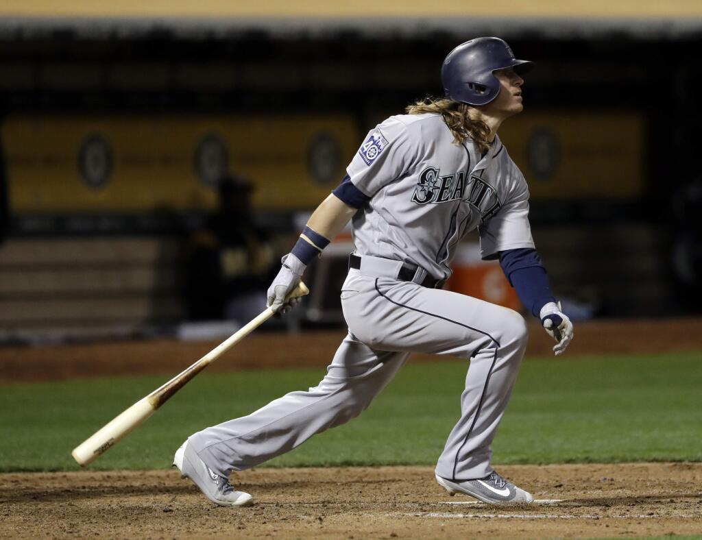 Seattle Mariners' Ben Gamel follows through on a 2-RBI double against the Oakland Athletics during the sixth inning of a baseball game against the Oakland Athletics Tuesday, Aug. 8, 2017, in Oakland, Calif. (AP Photo/Marcio Jose Sanchez)