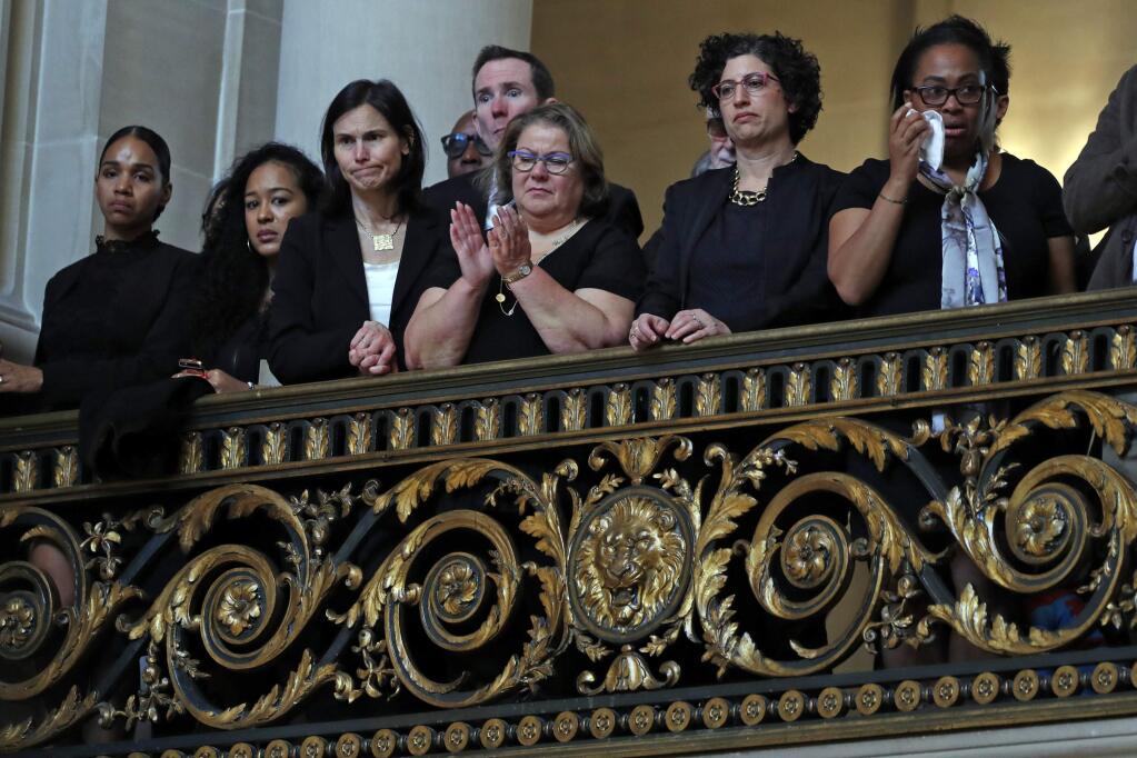 Attendees watch during a service celebrating the life of Mayor Ed Lee at San Francisco City Hall in San Francisco, Sunday, Dec. 17, 2017. San Francisco Mayor Ed Lee was remembered for his humility, integrity and infectious smile during a public celebration of his life Sunday at City Hall attended by family members, former staff, politicians and residents. (Scott Strazzante/San Francisco Chronicle via AP, Pool)