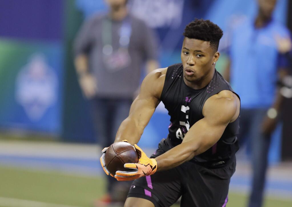 Penn State running back Saquon Barkley runs a drill during the NFL scouting combine, Friday, March 2, 2018, in Indianapolis. (AP Photo/Darron Cummings)