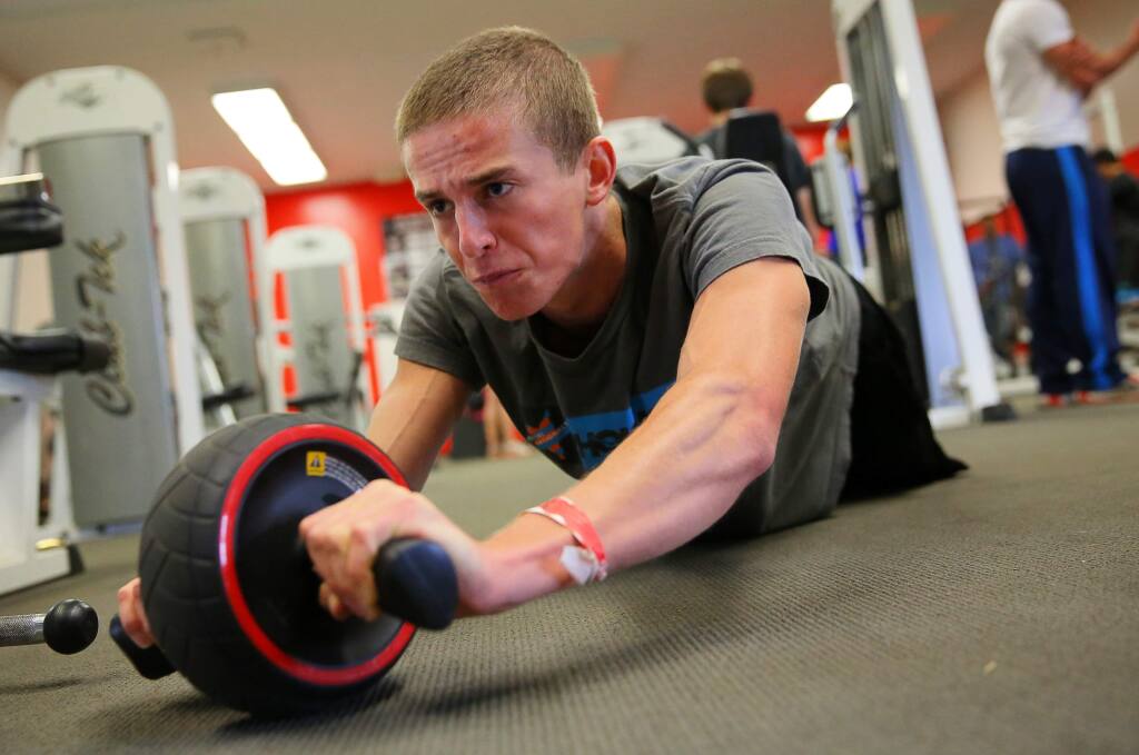 El Molino distance runner Brian Schulz works his core in the weight room during track practice, in Forestville, on Tuesday, April 12, 2016. (Christopher Chung/ The Press Democrat)