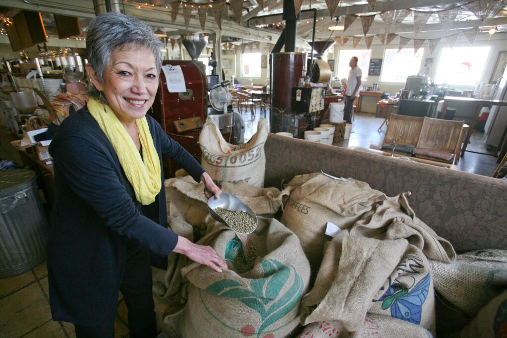 Sheila Bride scoops some raw coffee beans at her Petaluma Coffee and Tea company in Petaluma on Monday, March 23, 2015. (SCOTT MANCHESTER/ARGUS-COURIER STAFF)
