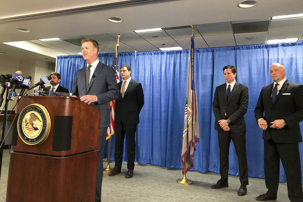 US attorney David Anderson announces criminal spy charges against a San Francisco Bay Area tour operator Xuehua Edward Peng Monday, Sept. 30, 2019, in San Francisco. Xuehua Edward Peng, who operates tours for Chinese students and visitors, was charged with being an illegal foreign agent and delivering classified U.S. national security information to officials in China, U.S. government officials announced Monday. (AP Photo/Janie Har)