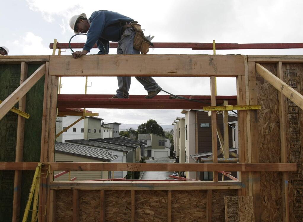 A man works on a housing construction project in Palo Alto, Calif., Wednesday, Feb. 16 , 2011. (AP Photo/Paul Sakuma, File)