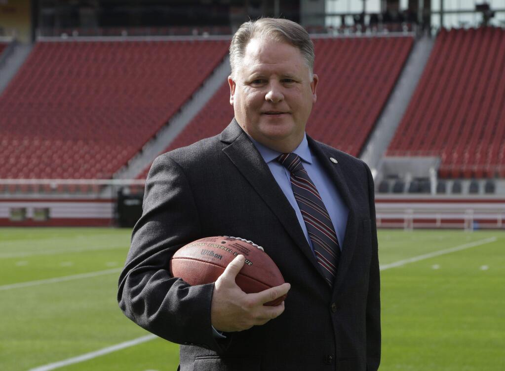 49ers head coach Chip Kelly poses for photographs at Levi Stadium after being introduced as the team's new coach. (Ben Margot / Associated Press)