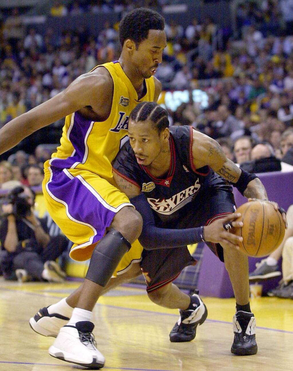 The Philadelphia 76ers' Allen Iverson, right, drives against the Los Angeles Lakers' Kobe Bryant during the first half of Game 2 of the NBA Finals Friday, June 8, 2001, in Los Angeles. (AP Photo/Kevork Djansezian)