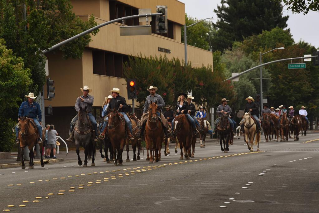 Horse riders make their way up E Street as they arrive for the start of the Cattle Drive Courthouse Square Celebration, sponsored by the Sonoma County Farm Bureau and held Sunday in downtown Santa Rosa, California. August 4, 2019.(Photo: Erik Castro/for The Press Democrat)
