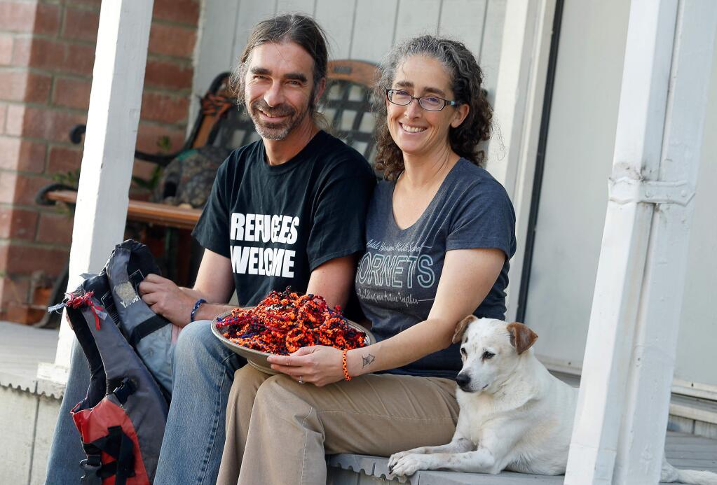 Mary Beth and Eric Leland pose for a portrait at their home in Petaluma, California, on Wednesday, August 29, 2018. Mary Beth Leland began the Refugee Hopelet Project which sells bracelets, dubbed hopelets, made of material from the discarded life jackets of refugees' journeys across the Mediterranean Sea. All the donations are given to refugee families and a Greek nonprofit. (Alvin Jornada / The Press Democrat)